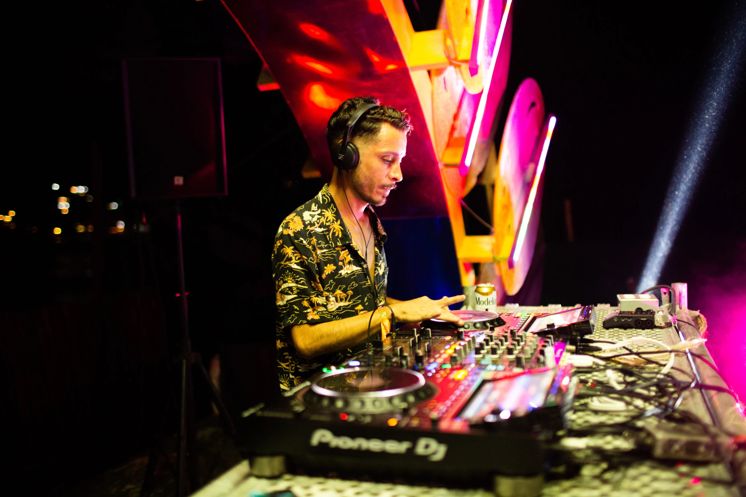 A DJ performing in a yellow shirt