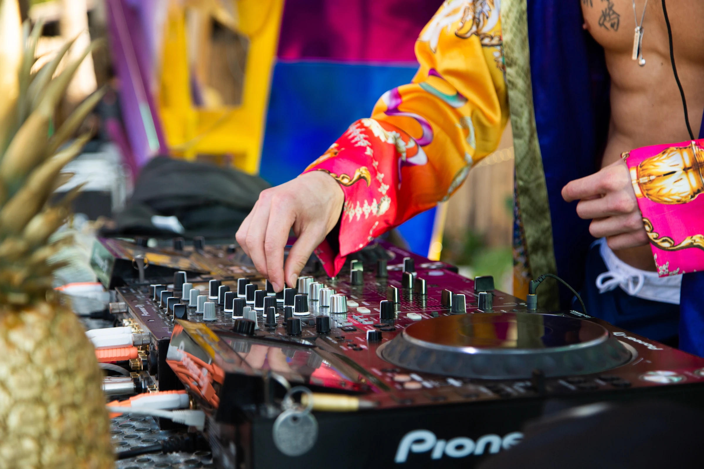 Hands adjusting a DJ mixer