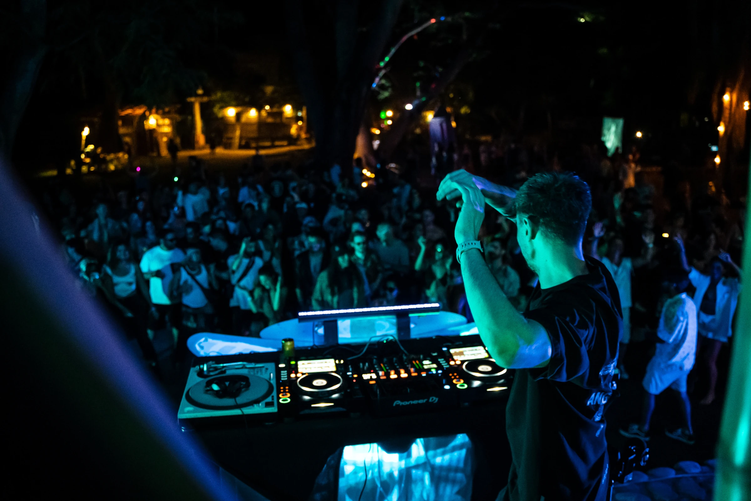 A performer beside the crowd under blue lights