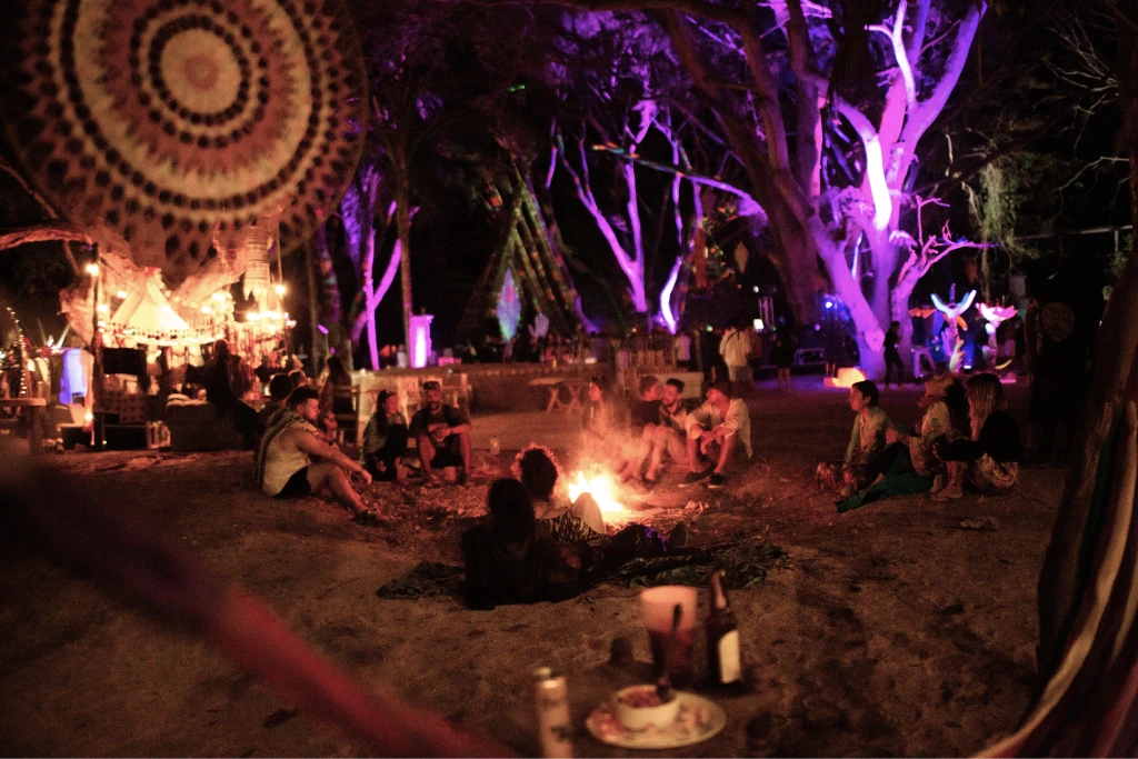 An illuminated dance floor among the trees